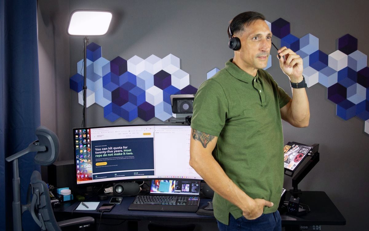 Jarrod Roberts standing in his office in a headset, on a call.